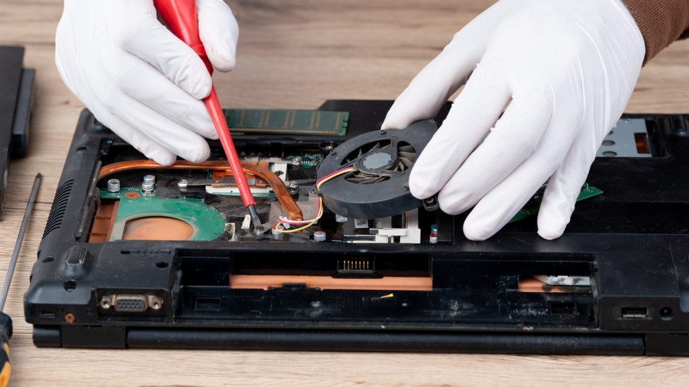 A laptop computer dismantled for repair on internal equipment.