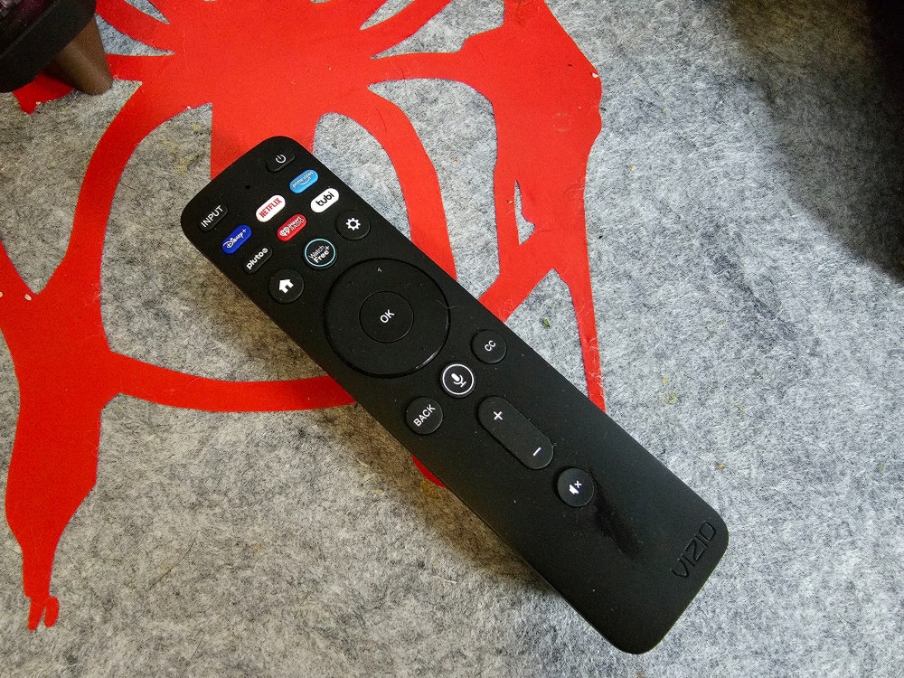 A Roku remote on a deskmat