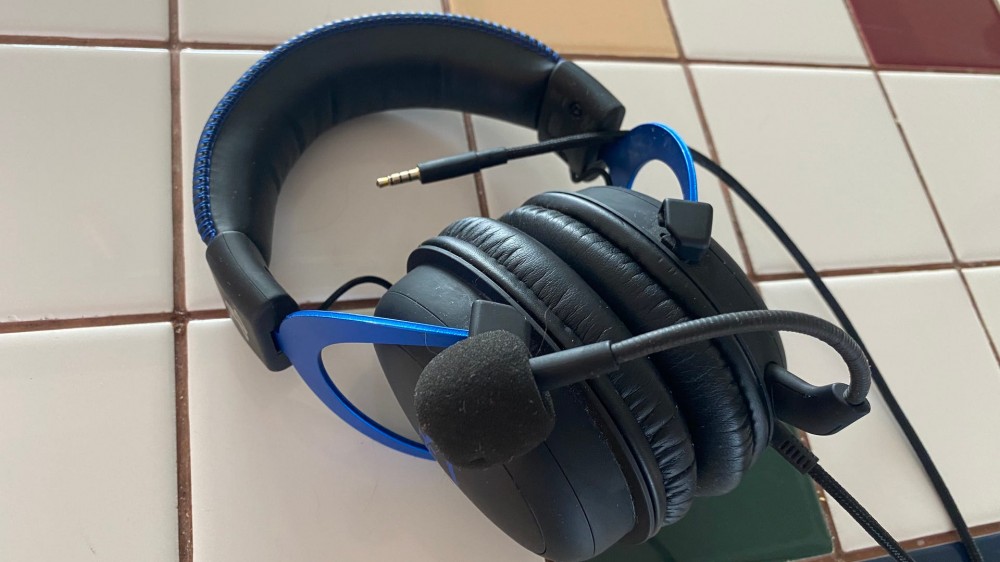 A pair of wired headphones sitting on a counter top